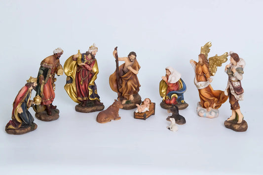 Complete 11-piece nativity figurine set on neutral background — Holy Family, Three Kings, Gloria angel, shepherd, and stable animals arranged as full crèche display