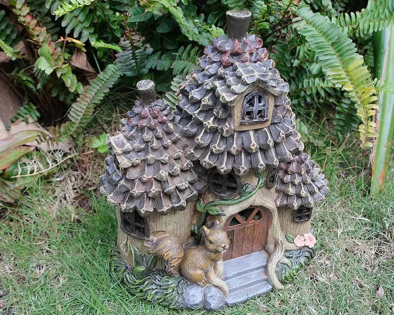 Hand-painted squirrel fairy house in outdoor garden