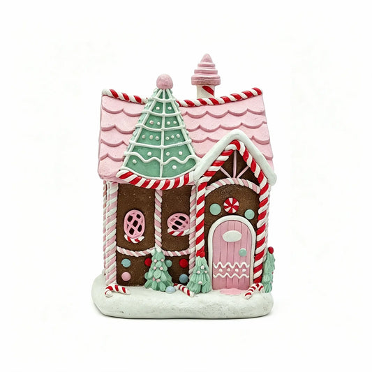 A decorative Gingerbread Cottage Figurine with pink and white candy-striped roof and trim, shown on a plain white background.