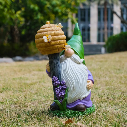 Bee garden gnome statue with green hat and beehive staff, whimsical outdoor yard decor