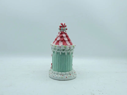 Back view of the gingerbread house ornament showing mint-green paneled walls and icing swag details