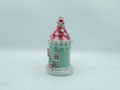 Side view of hand-painted candyland gingerbread house figurine with mint-green walls and peppermint candy roof