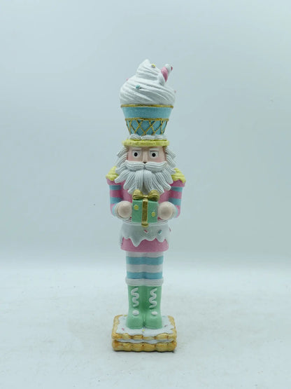 A decorative nutcracker figurine styled as a soldier wearing a light blue and pink ice cream cone uniform, standing on a white background.