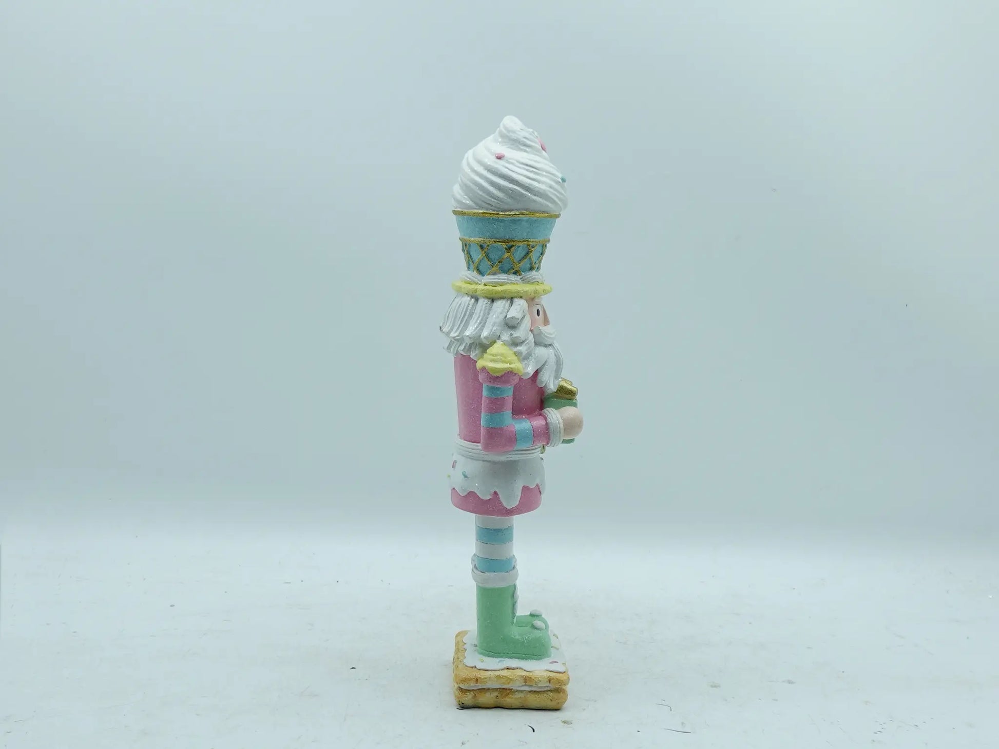 Right side view of the hand-painted resin nutcracker figurine with gift box