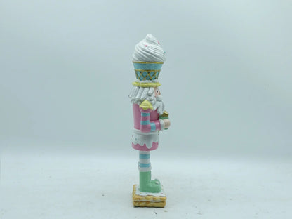 Right side view of the hand-painted resin nutcracker figurine with gift box
