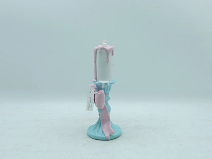 resin candle holder figurine displaying the flowing pink ribbon bow detail, side view