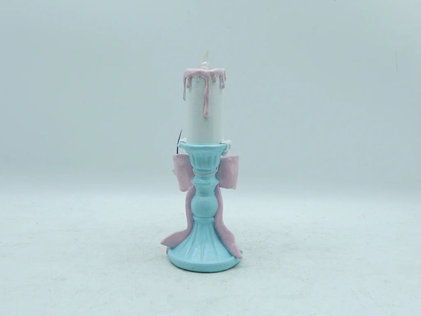 pastel candle holder figurine showing the sky-blue fluted pedestal base and trailing ribbon, back view