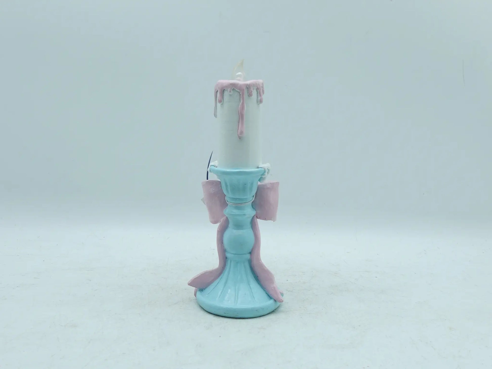 pastel candle holder figurine showing the sky-blue fluted pedestal base and trailing ribbon, back view
