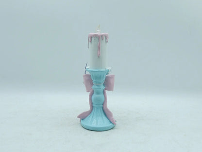 pastel candle holder figurine showing the sky-blue fluted pedestal base and trailing ribbon, back view