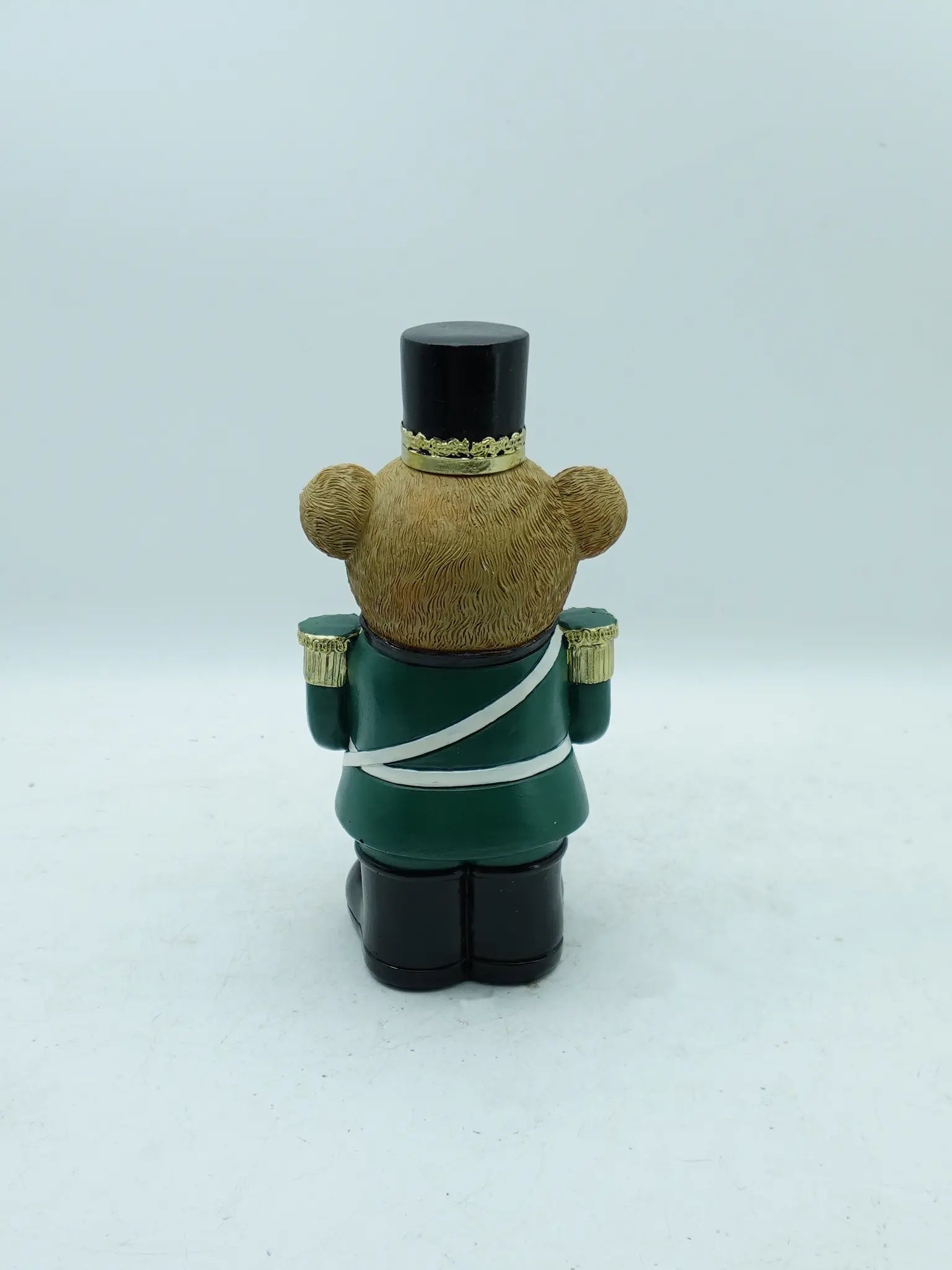 the teddy bear drummer figurine in green uniform, back view