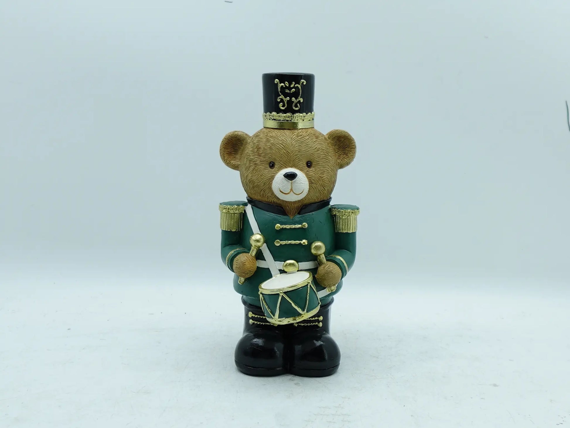 Hand-painted Christmas teddy bear drummer in forest green uniform with gold details and black top hat, front view