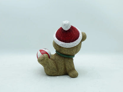 the Christmas teddy bear figurine showing the textured knit hat, green collar, and furry back
