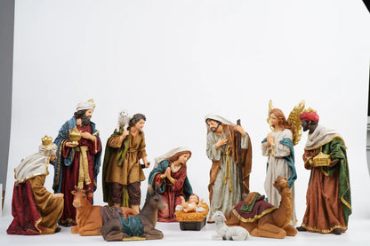 Complete 12-piece colorful nativity scene on white studio background showing full crèche arrangement