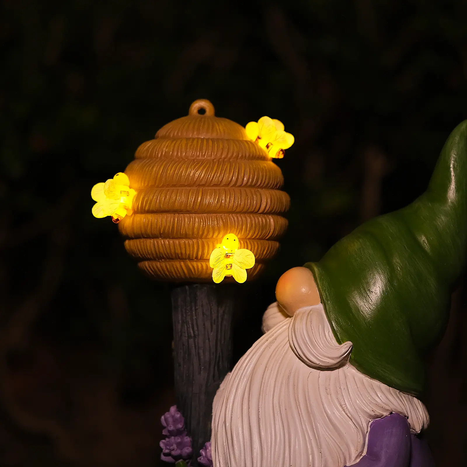 beehive topper with glowing bee-shaped LED lights on garden gnome statue