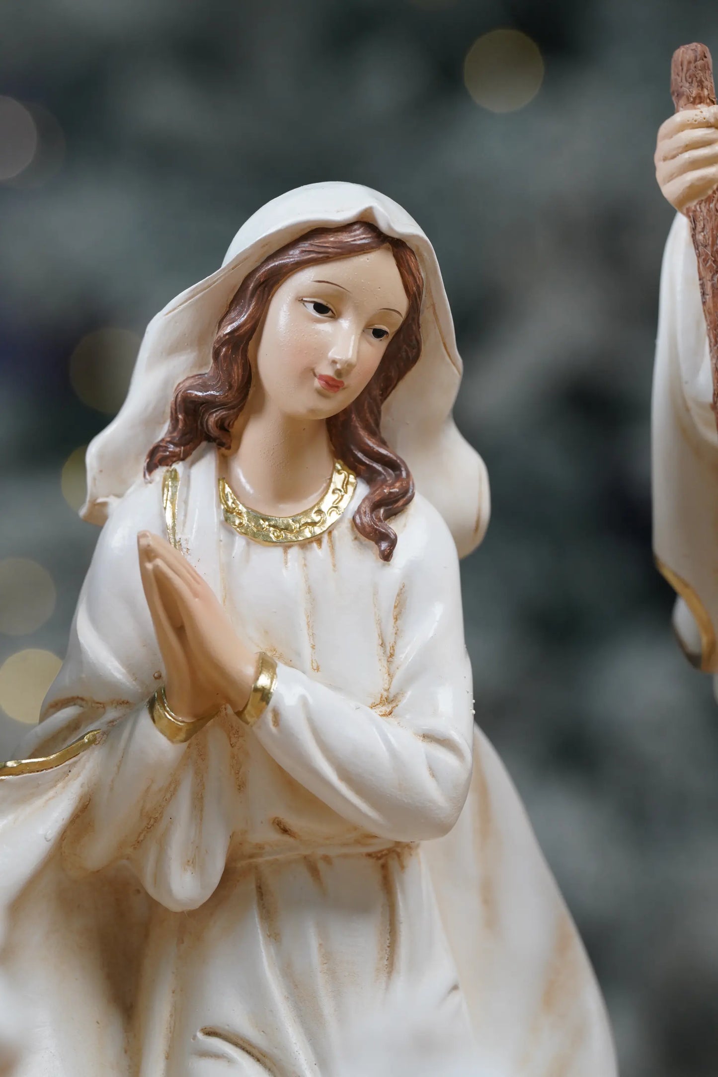 White and gold Virgin Mary nativity figurine close-up