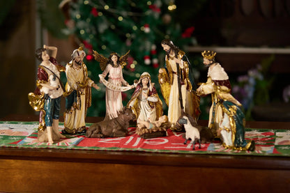 11-piece nativity figurine set on holiday Christmas table runner viewed from alternate angle