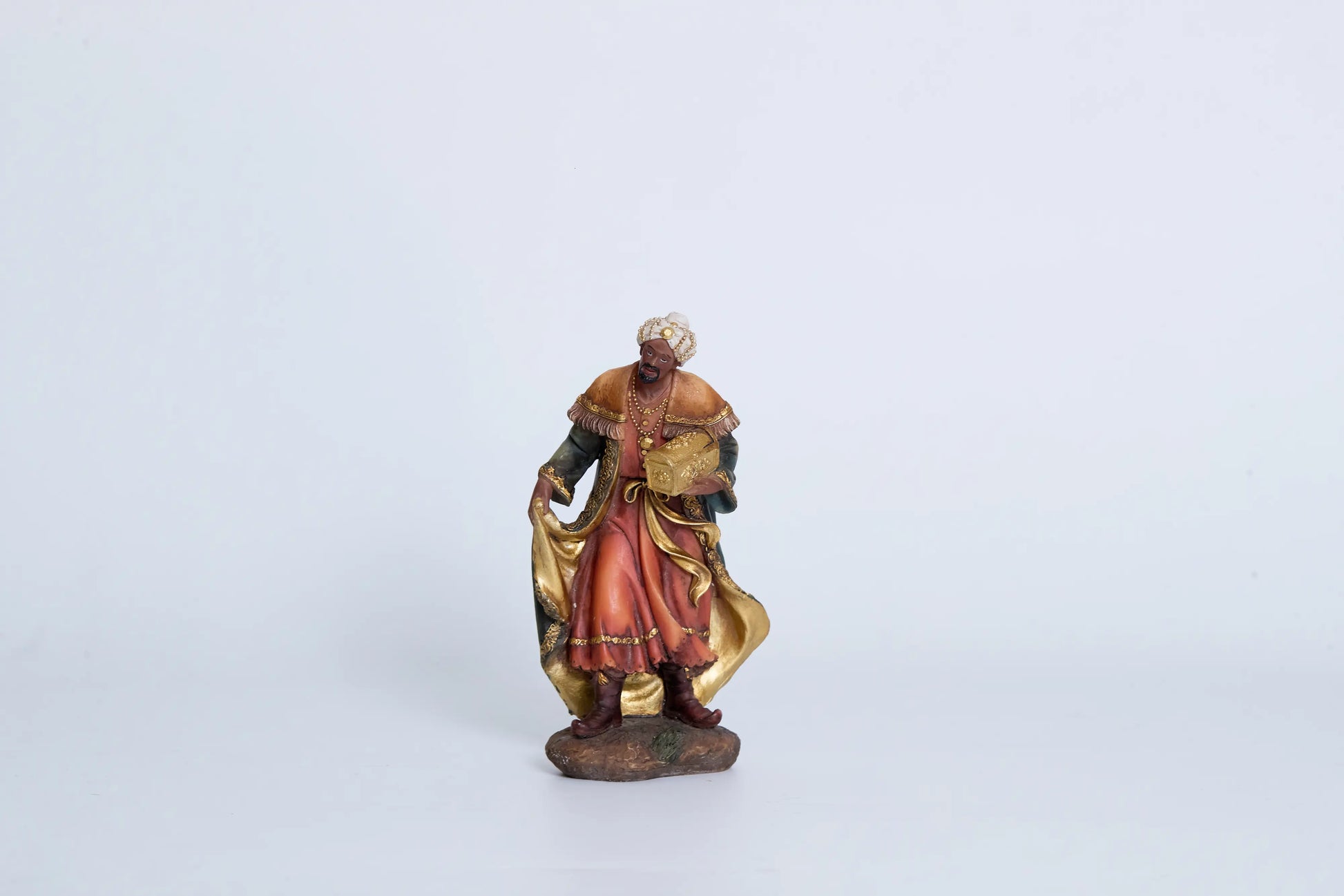Nativity Wise Man figurine close-up — standing Magi in teal-and-gold robes carrying jeweled chest, hand-painted resin Three Kings figure