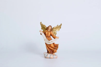 Herald angel nativity figurine close-up — Gloria banner angel with spread gold wings and flowing amber robe standing on cloud pedestal, hand-painted resin