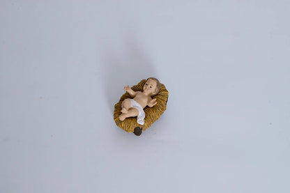 Baby Jesus in manger close-up — hand-painted resin nativity figurine detail