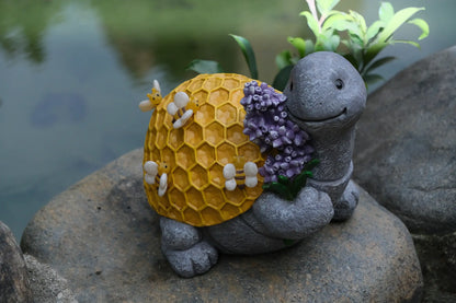 Bee turtle yard decor on rock by plants, honeycomb shell detail outdoor garden accent