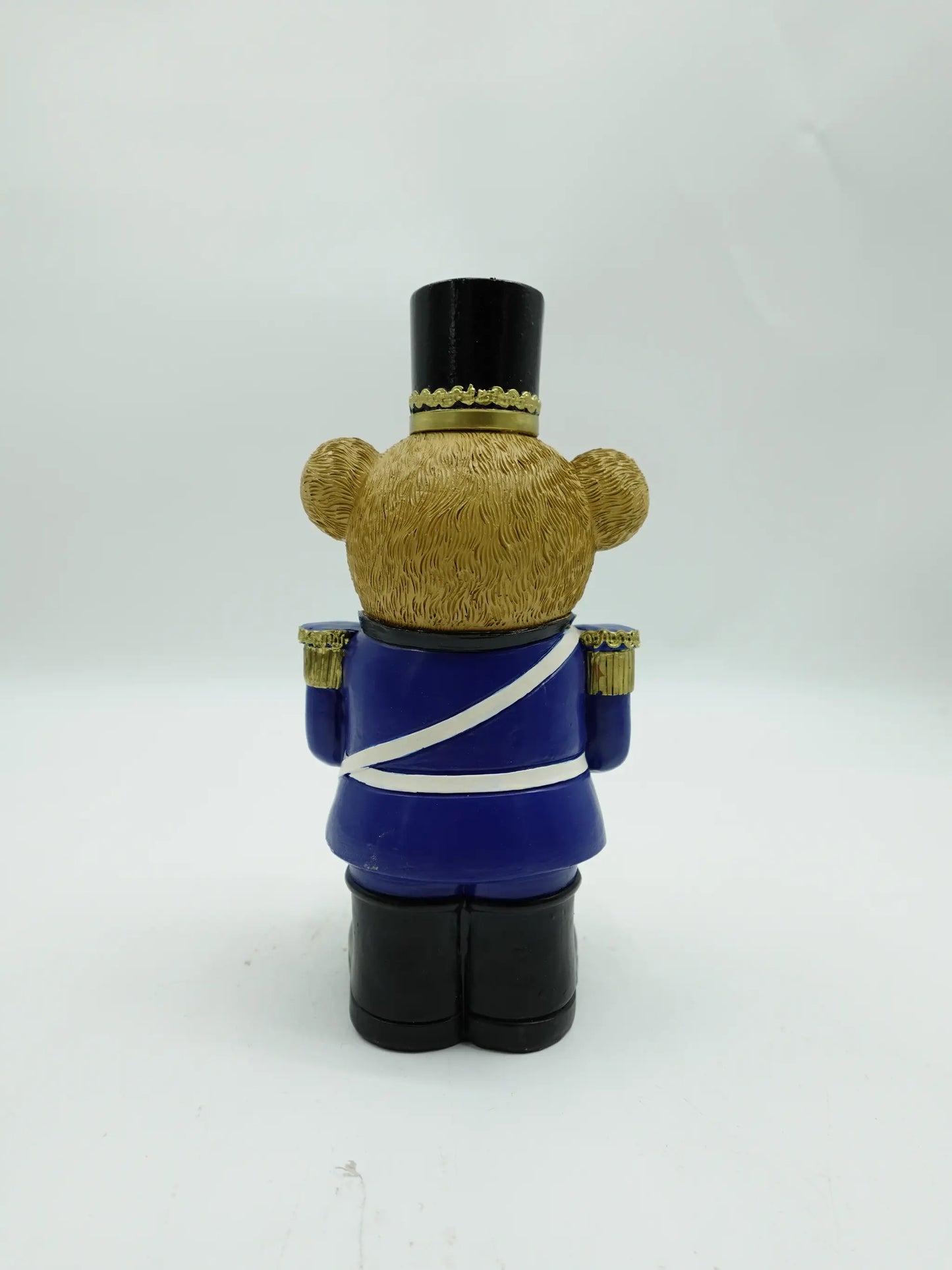 the Christmas teddy bear drummer figurine in blue uniform, back view