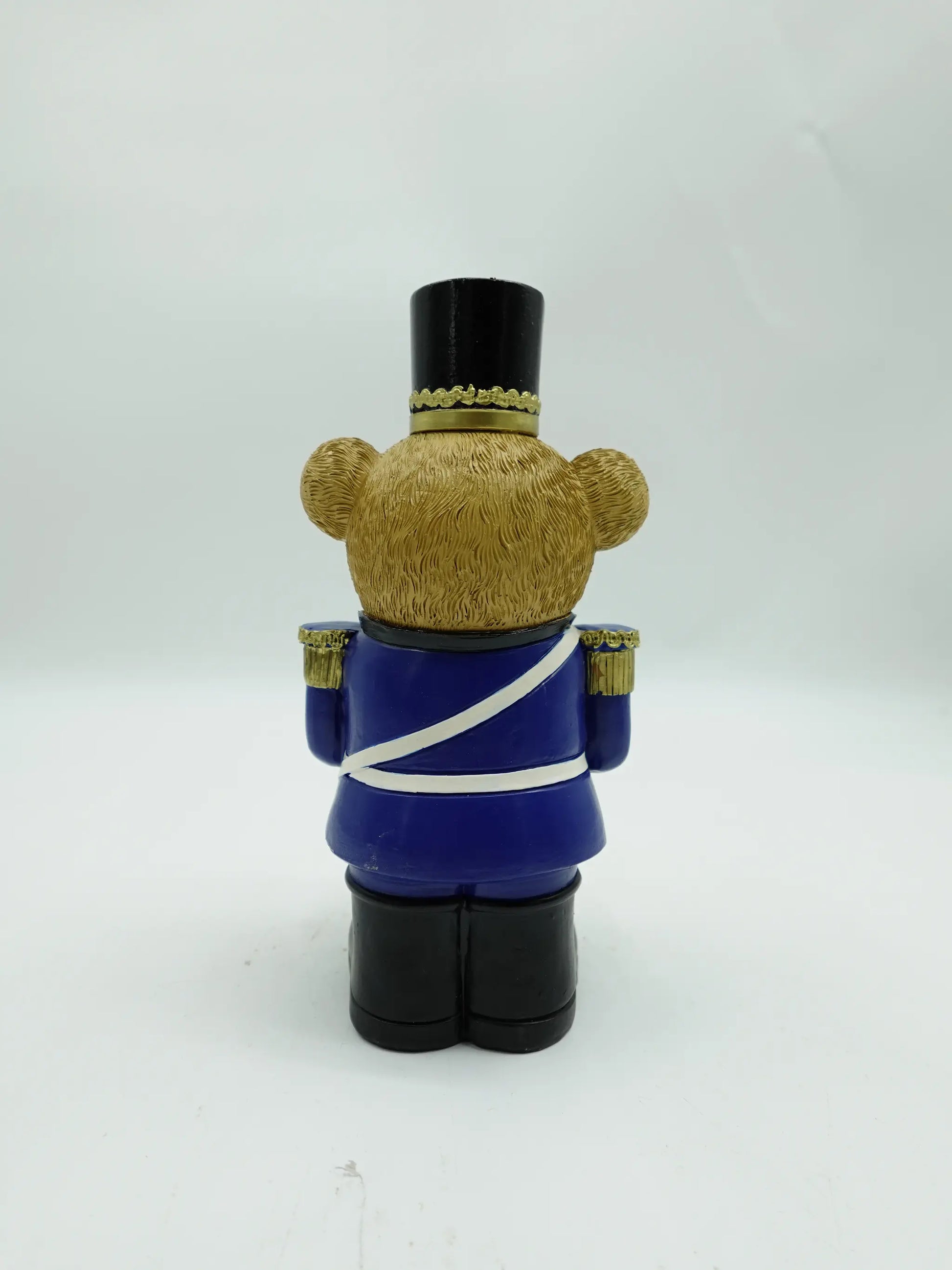 the Christmas teddy bear drummer figurine in blue uniform, back view