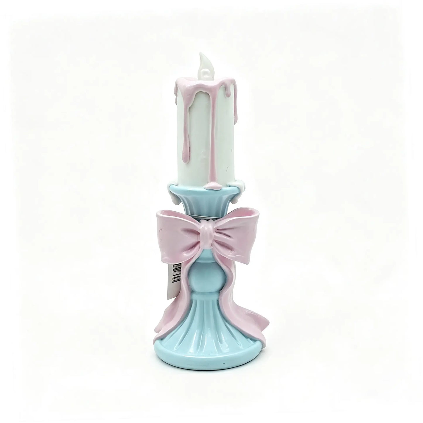 resin candle holder figurine with white candle, pink wax drips, and sky-blue pedestal base on white background