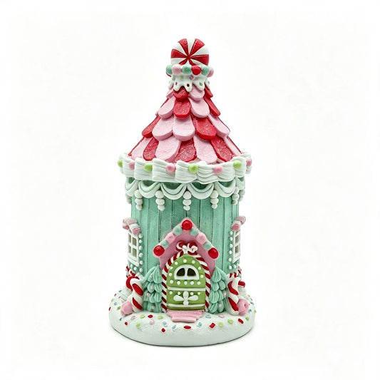 A decorative gingerbread house figurine, shown on a plain white background.